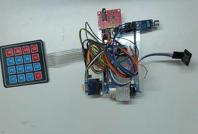 The breadboard prototype with sensors, wiring, a keypad and a small display