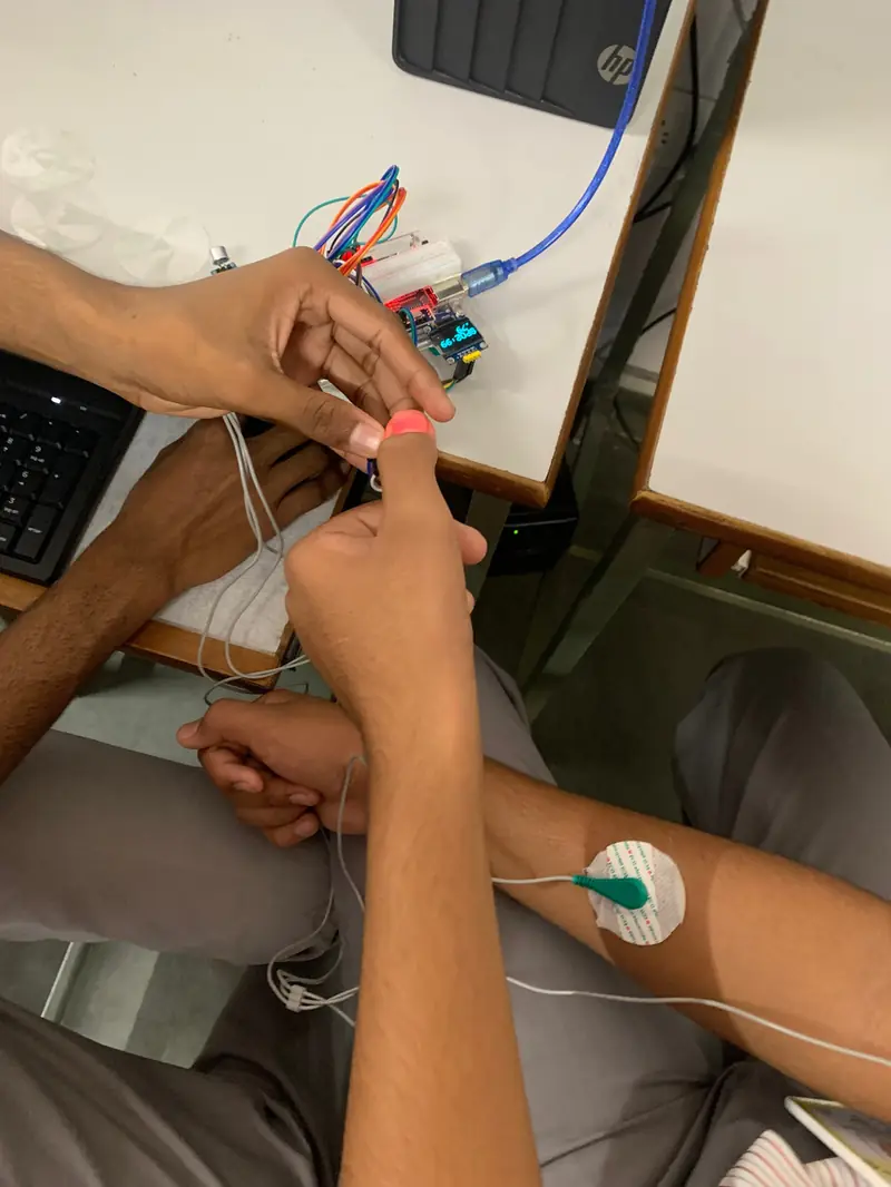 Hands attaching sensor leads during a prototype test